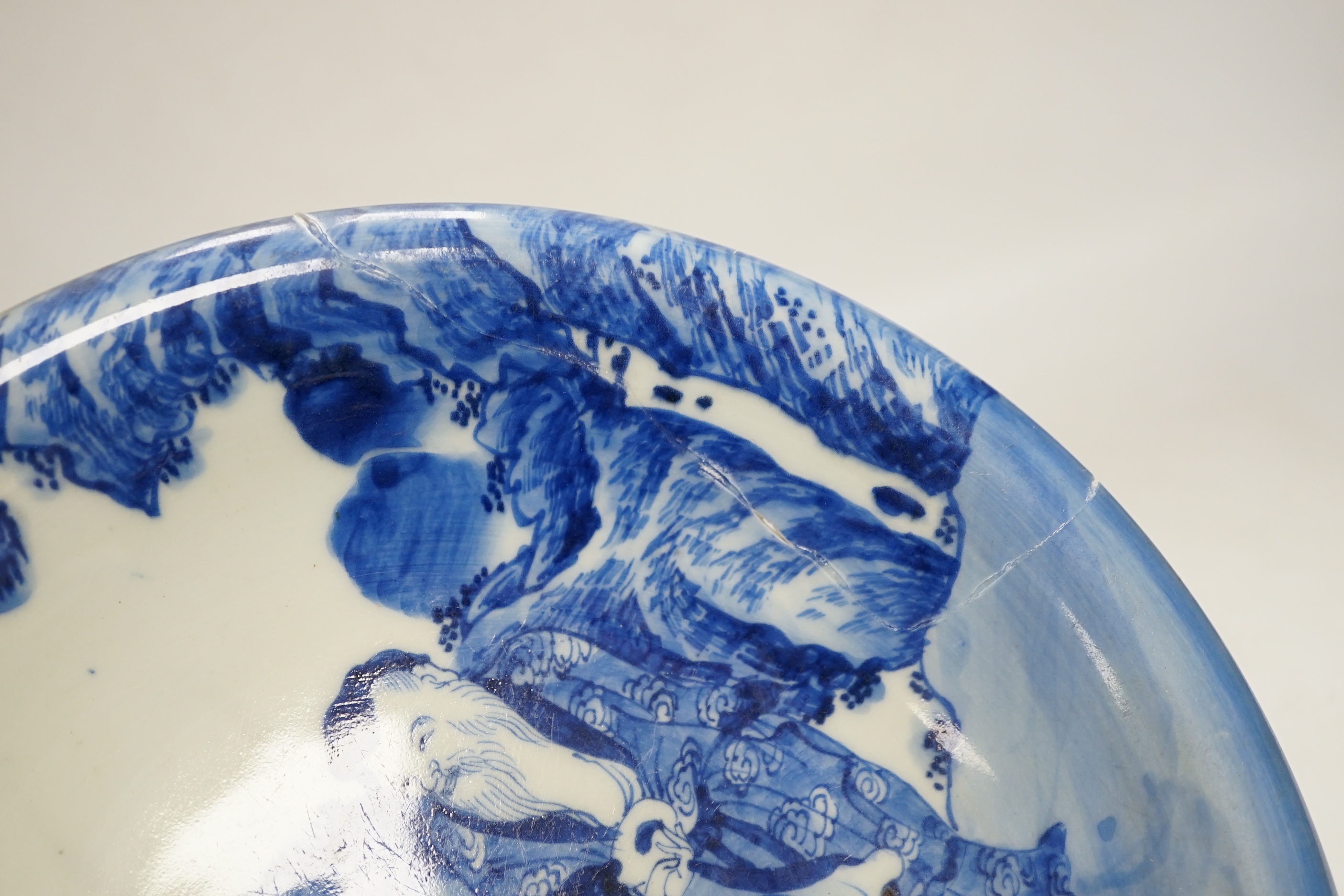 Assorted Chinese and Japanese ceramics comprising a famille rose bowl, two blue and white plates and a blue and white bowl, largest 30cm in diameter